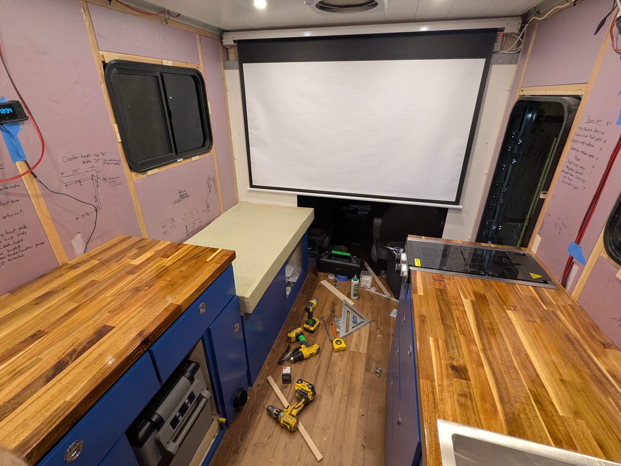 Custom ski van build in progress — projector screen and cabinetry